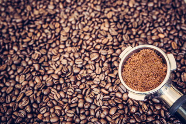 istock Espresso machine scoop on coffee beans background 936369706