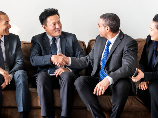 istock Business people sitting together on couch 936370010