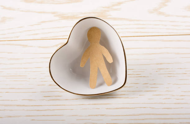 istock Paper man shape in  a heart shaped bowl 936370656