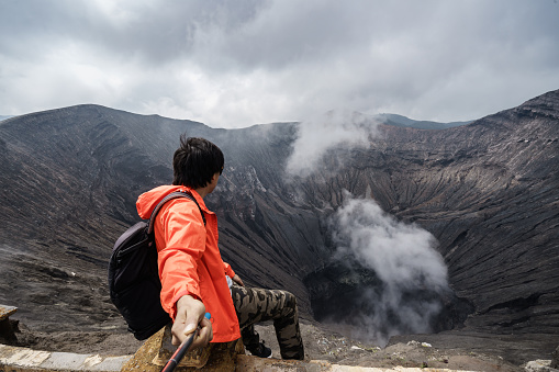 Traveler at crater volcano at Bromo (Gunung Bromo) an active volcano in the Bromo Tengger Semeru National Park, East Java, Indonesia