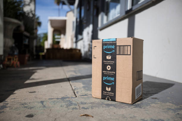 Cardboard package delivery at front door Los Angeles CA, November 11/22/2017: Image of an Amazon packages. Amazon is an online company and is the largest retailer in the world. Cardboard package delivery at front door during the holiday season. shipping package parcel box on wooden floor with protection paper inside. Amazon.com went online in 1995 and is now the largest online retailer in the world. amazon.com photos stock pictures, royalty-free photos & images