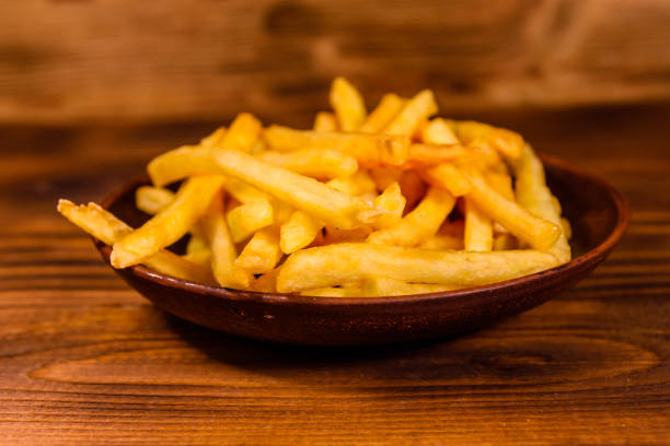istock Ceramic plate with french fries on wooden table 936371702