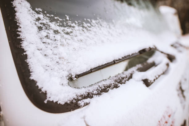 istock Close up of frozen windshield wiper with snow. 936373390