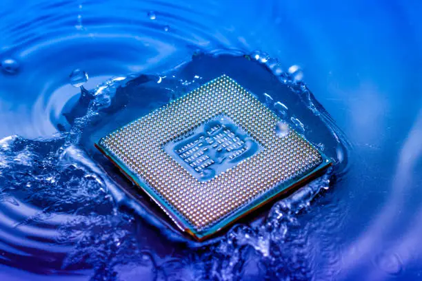 technology cyber electronic concept. cpu ram computer Fall into the water on blue light background. CPU cooling with water