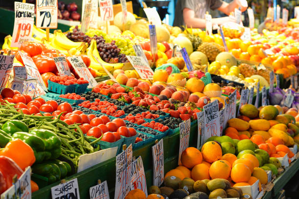 San Francisco, USA  - May 21, 2013: Woman buying fresh peaches on farmer's market