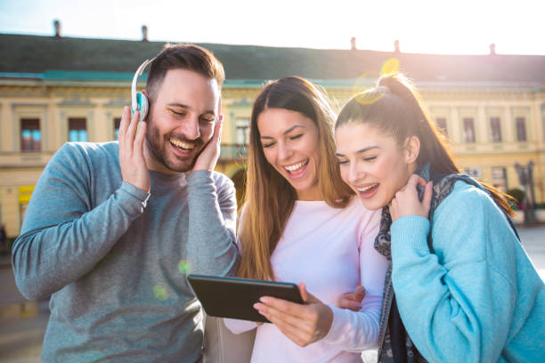 istock Group of smiling friends with digital tablet outdoor 936376982