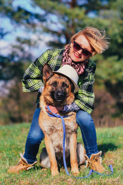 istock German Shepherd playing with pretty girl in the forest 936377948