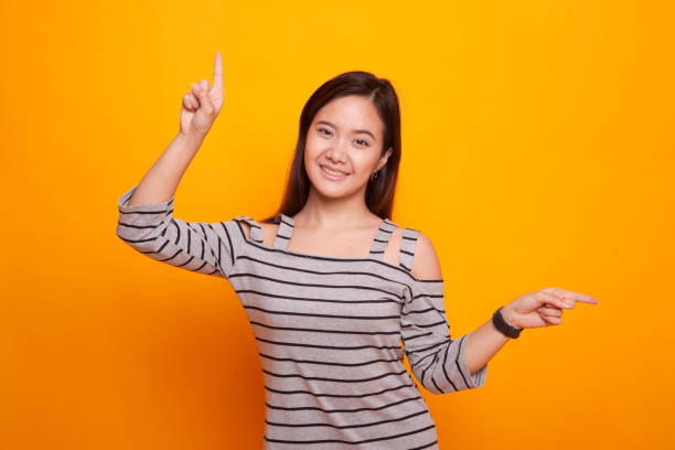 istock Young Asian woman point with two hands. 936379248