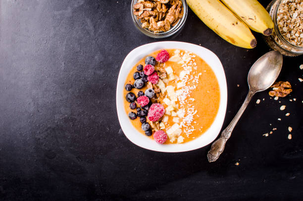 istock Smoothie bowl from apricot with berries and nuts 936379542