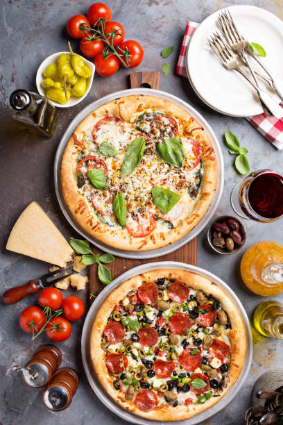 istock Margherita and pepperoni pizza with basil 936379560