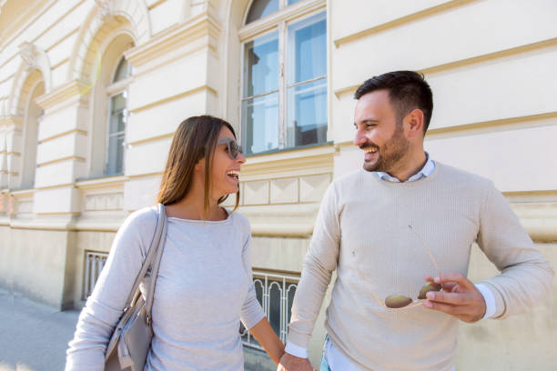 istock Beautiful young couple smiling while walking outdoors on sunny day 936379578