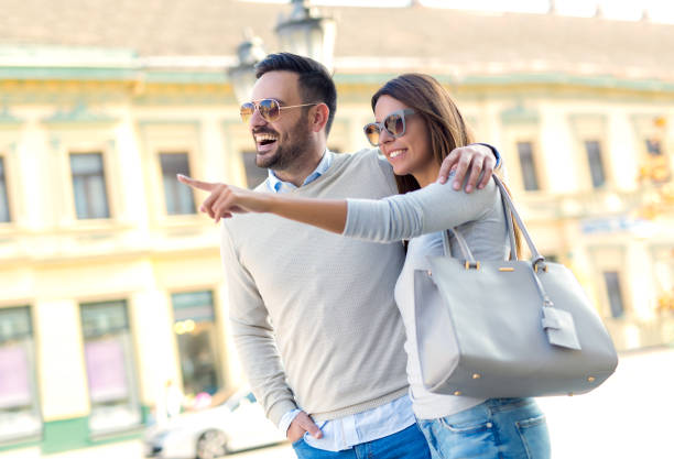 istock Beautiful young couple smiling while walking outdoors on sunny day 936379644