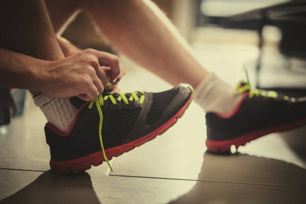 istock Close up of unrecognizable athlete tying shoelaces. 936380910