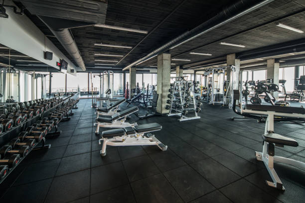 Gym without people with large group of exercise machines. Large group of exercise machines and equipment in a gym. exercise machine photos stock pictures, royalty-free photos & images
