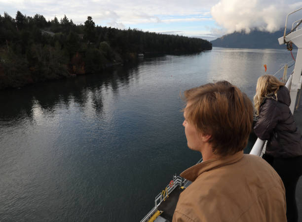 istock Young man looking off from ferry boat 936382340