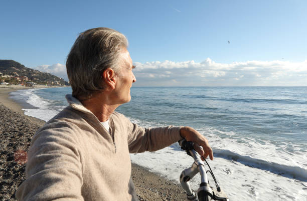 istock Man relaxes with bike, at beach 936383640
