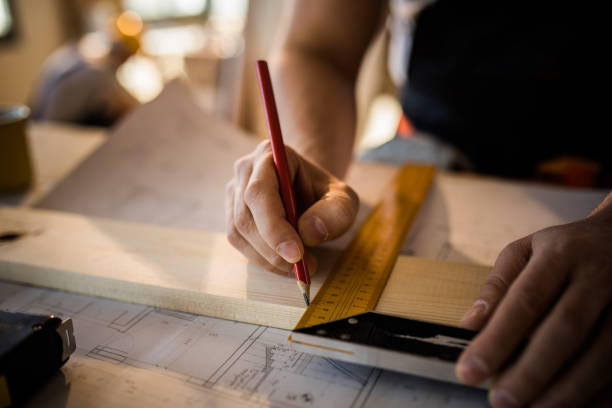 istock Close up of unrecognizable worker drawing on wood plank. 936384632