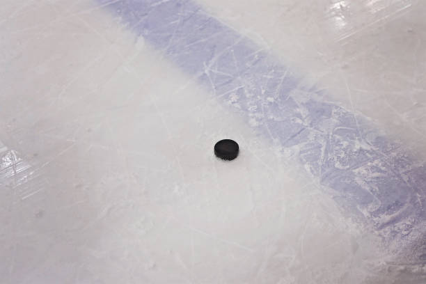 istock Hockey puck on ice 936385766