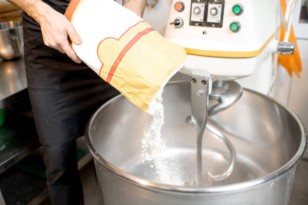 istock Filling flour into the kneader at the bakery 936388450