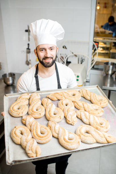 istock Baker with tray full of sweet pastry 936389140