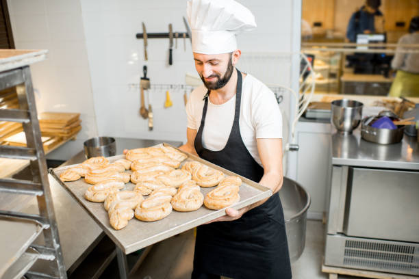 istock Baker with tray full of sweet pastry 936389378