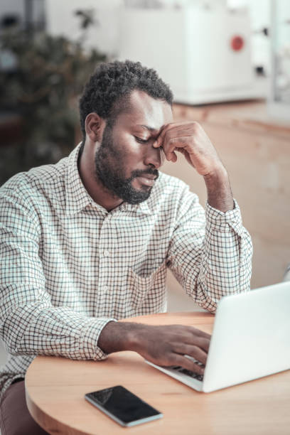 istock Cheerless young man holding his head 936390134