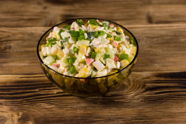 istock Salad with crab sticks, sweet corn, cucumber, eggs, rice and mayonnaise 936391138