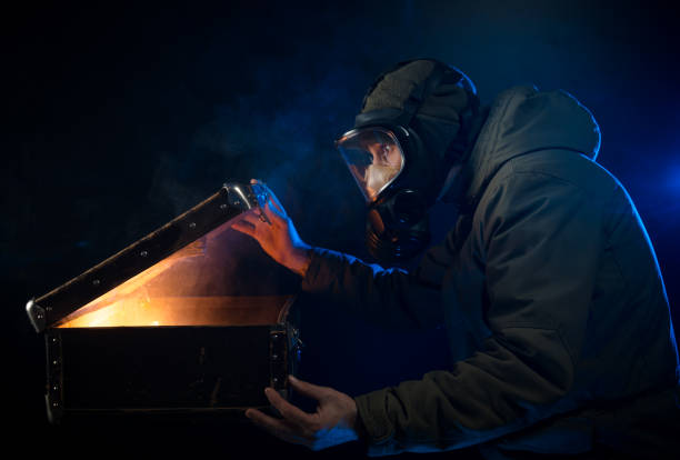 istock the man in the gas mask opens an old suitcase 936392390