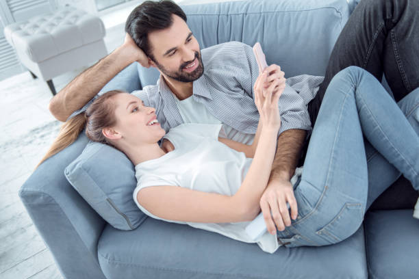istock Positive delighted young people lying on couch 936392588