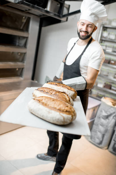 istock Baker with baked breads at the bakery 936392610