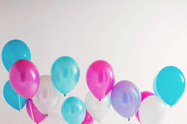 istock balloons on white wooden background 936393784