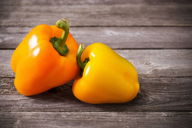istock pepper on old wooden background 936393836
