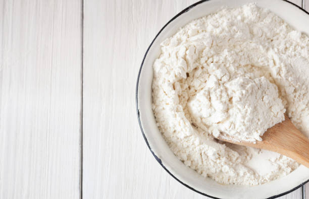 istock Making dough, baking. Bowl with flour on wood desk 936394558