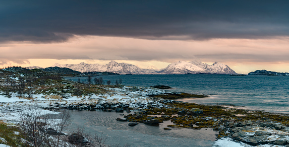 Sunset view on Hadseløya island from Langøya on the Vesteralen in Northern  Norway during a cold winter sunset.