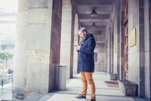 istock Young businessman using mobile phone outdoors 936397586