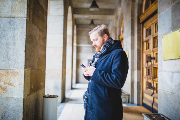 istock Young businessman using mobile phone outdoors 936397636