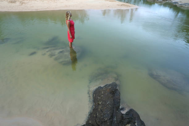 She stands in middle of pond.