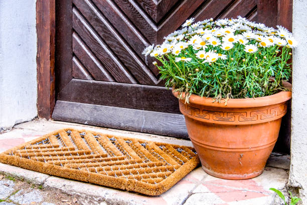 House with oleander in terracotta flower pot and bench in a Portuguese village.