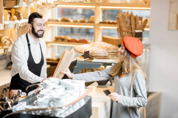 istock Buying a baguette in the bakery store 936400416