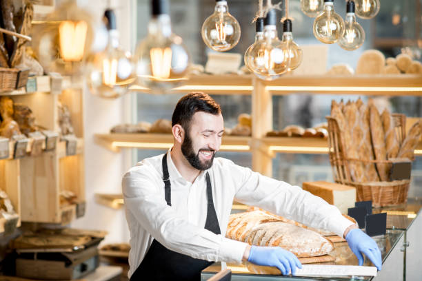 istock Seller in the bread store 936400728