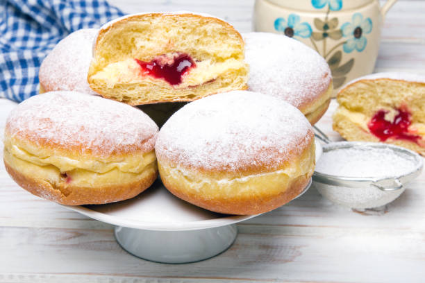 istock Traditional Polish donuts on wooden background.  Tasty doughnuts with jam. 936401232