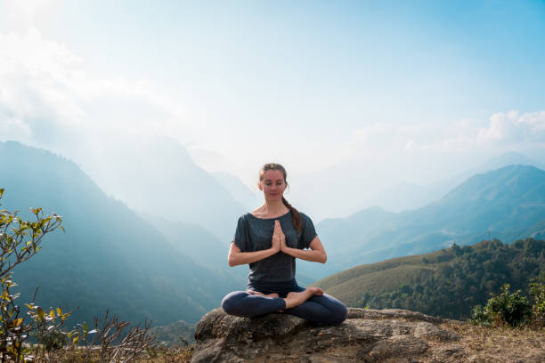 istock Meditating in lotus position, doing yoga exercises in morning 936401668