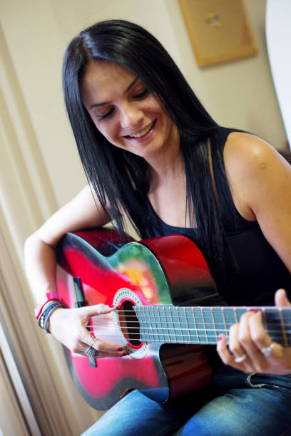 istock Musician girl with Guitar 936401714