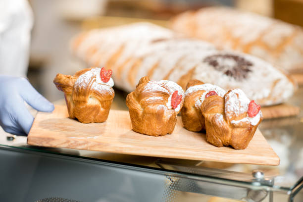 istock Putting maffins in the bakery store 936402526