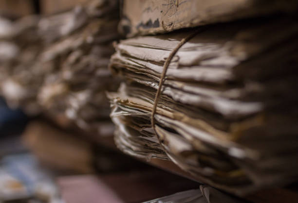 Files in Archive Room Old dusty stack of papers, files, documents on the shelves of archive room old file folder stock pictures, royalty-free photos & images