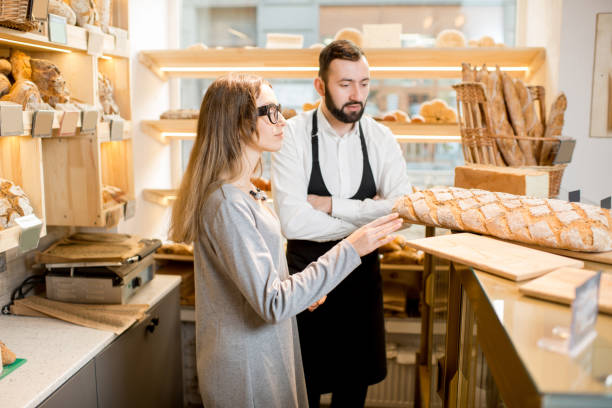 istock Owner of the bakery store with bread seller 936404100