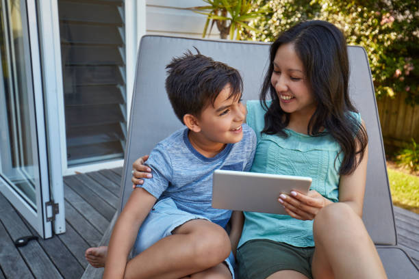 istock Happy mother and son using touchpad outdoors 936404622
