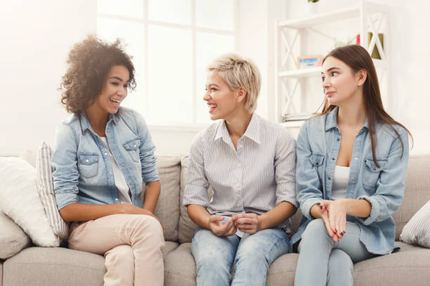 istock Female friends chatting at home 936404642