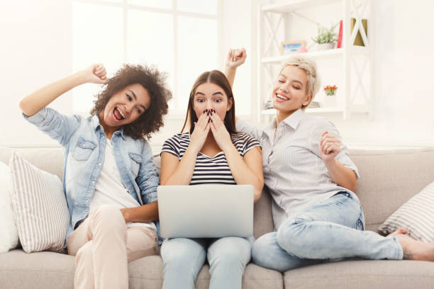 istock Three surprised women using laptop at home 936405146