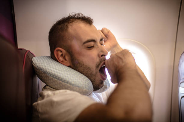 istock Tired man in airplane. Traveling. 936405684